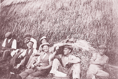 Farm workers take a rest by haystack, c.1938