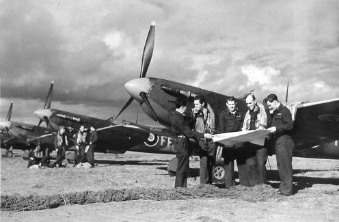 Pilots standing beside Spitfires at Newchurch*